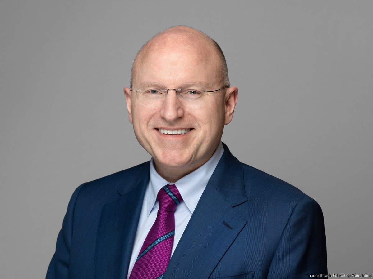 Headshot of Stephen Moret, President of Strada, wearing a dark blue suit and dark purple tie, smiling at the camera.